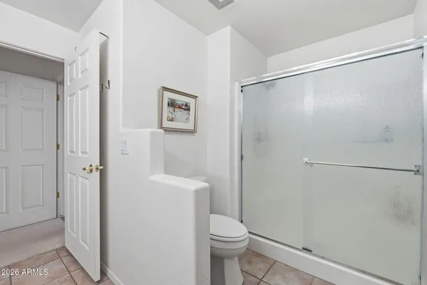 a bathroom with a shower and a toilet