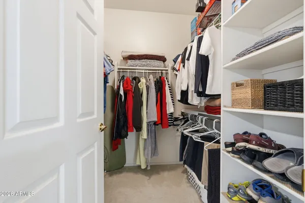a view of walk in closet with clothes