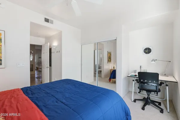 a bedroom with a bed and a desk