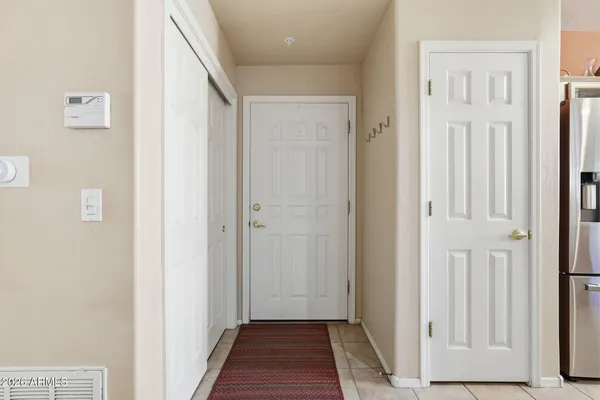 a view of a hallway with wooden floor and entryway