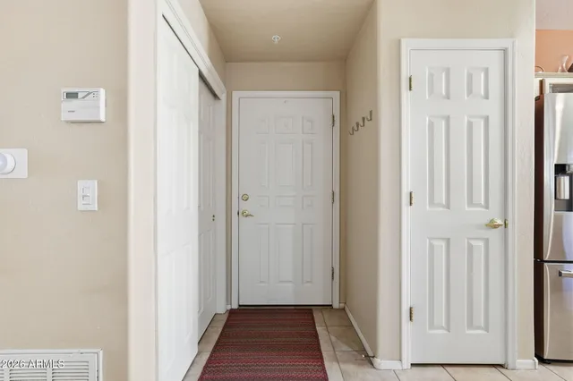 a view of a hallway with wooden floor and entryway