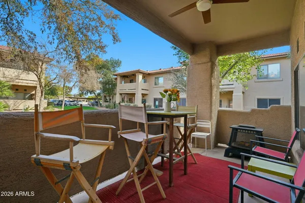 a view of a patio with table and chairs and potted plants