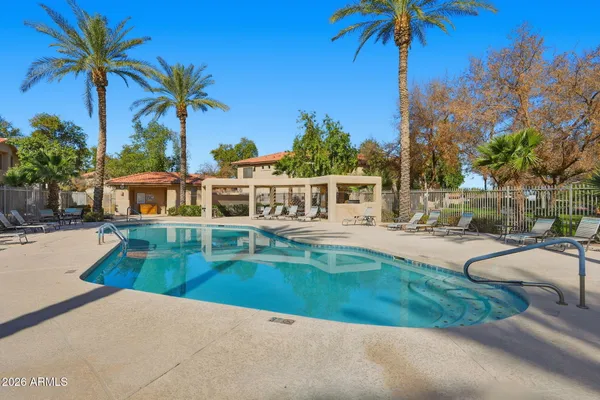 a view of a house with swimming pool and sitting area