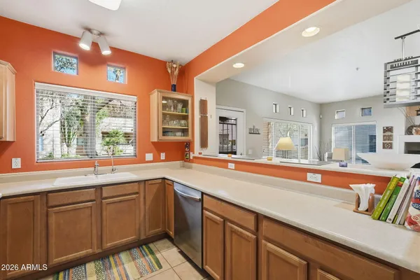 a large kitchen with cabinets a sink and a window