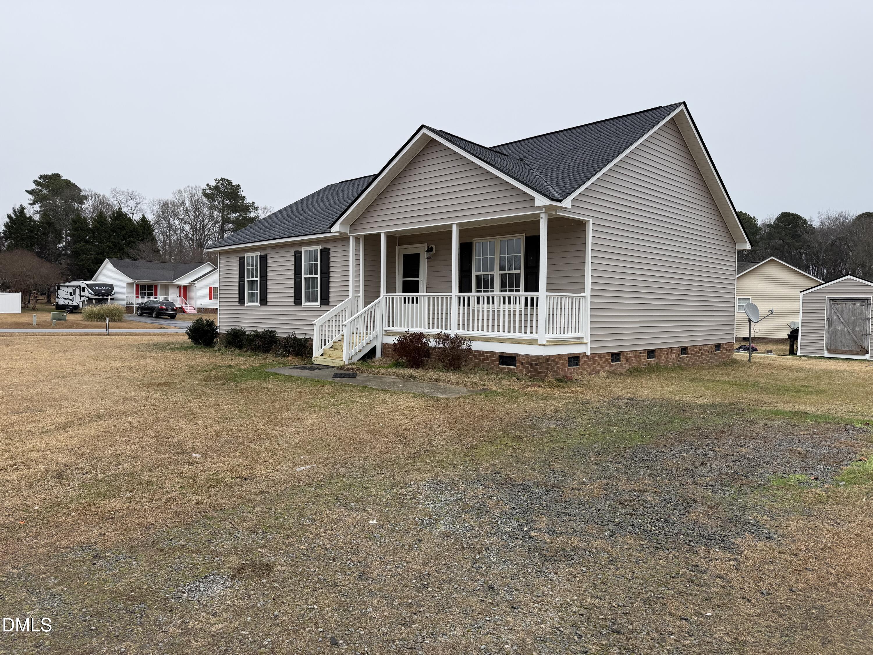 101 Copper Stone Street Smithfield, NC 27577 - Photo 12 of 32 a front view of a house with a yard and trees