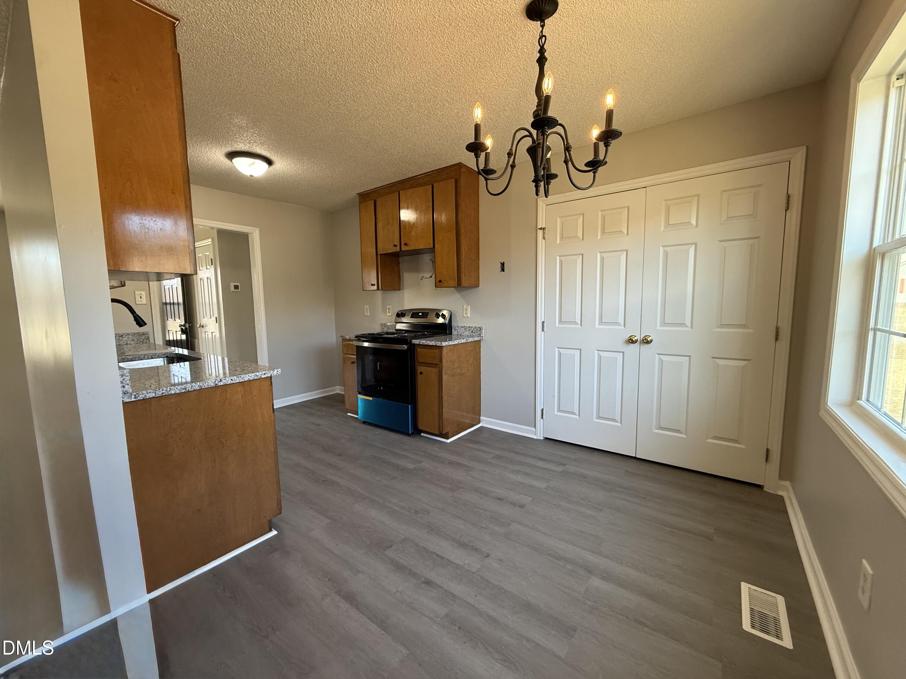 101 Copper Stone Street Smithfield, NC 27577 - Photo 24 of 32 a view of a kitchen with furniture and wooden floor