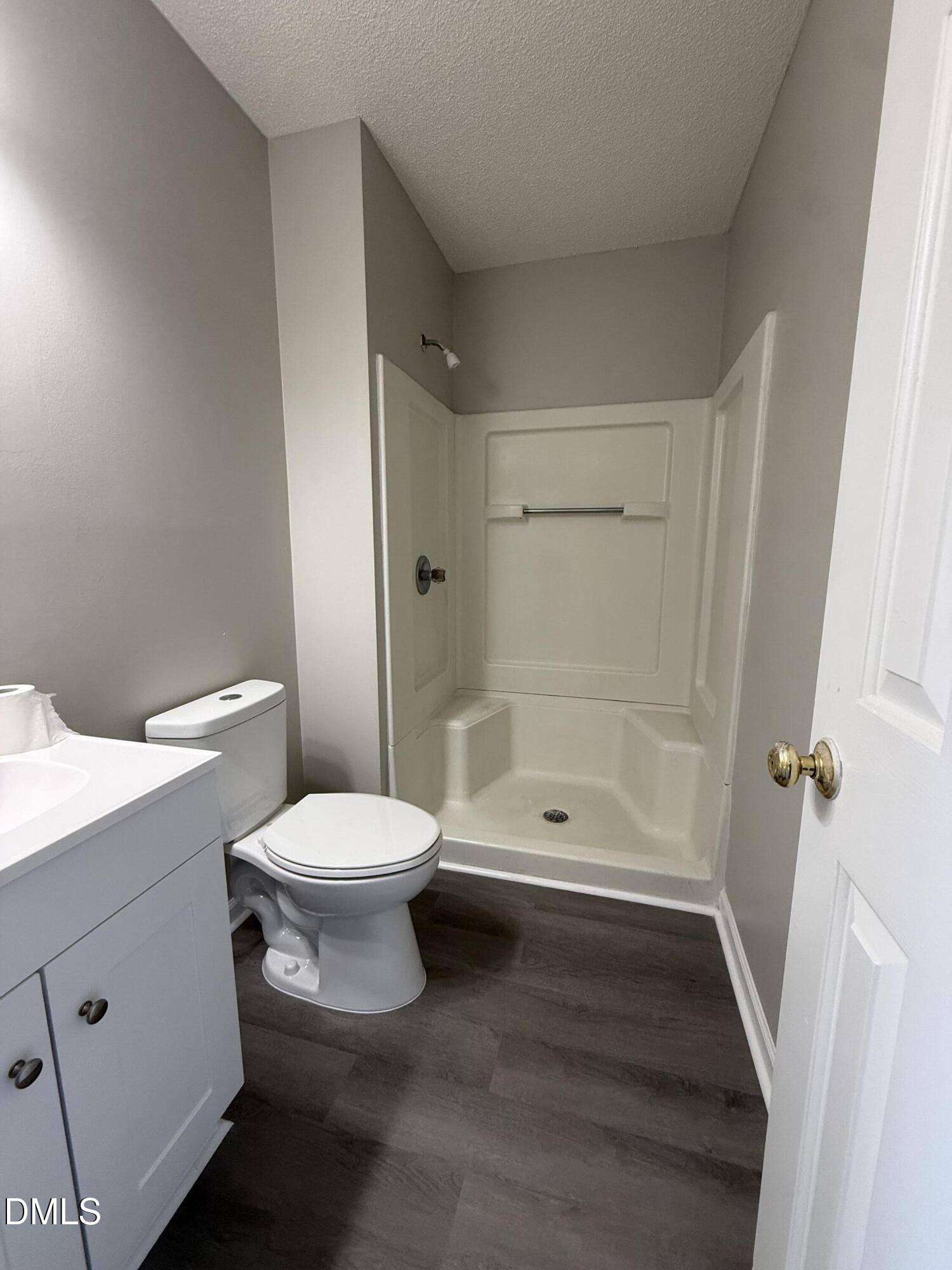 101 Copper Stone Street Smithfield, NC 27577 - Photo 28 of 32 a bathroom with a toilet a sink and shower