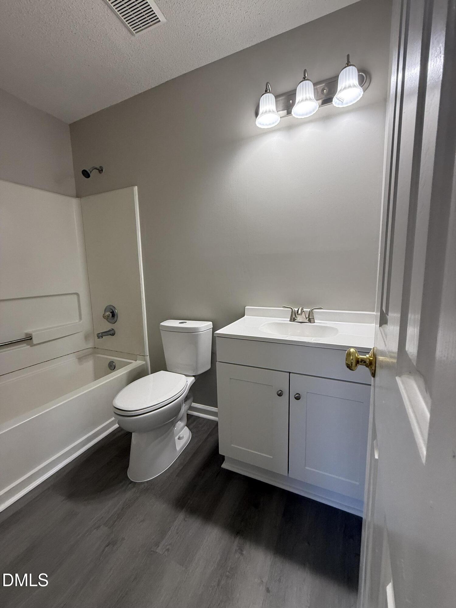 101 Copper Stone Street Smithfield, NC 27577 - Photo 31 of 32 a bathroom with a toilet sink and mirror