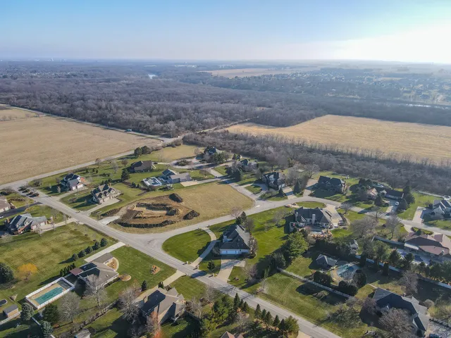 an aerial view of residential houses with outdoor space