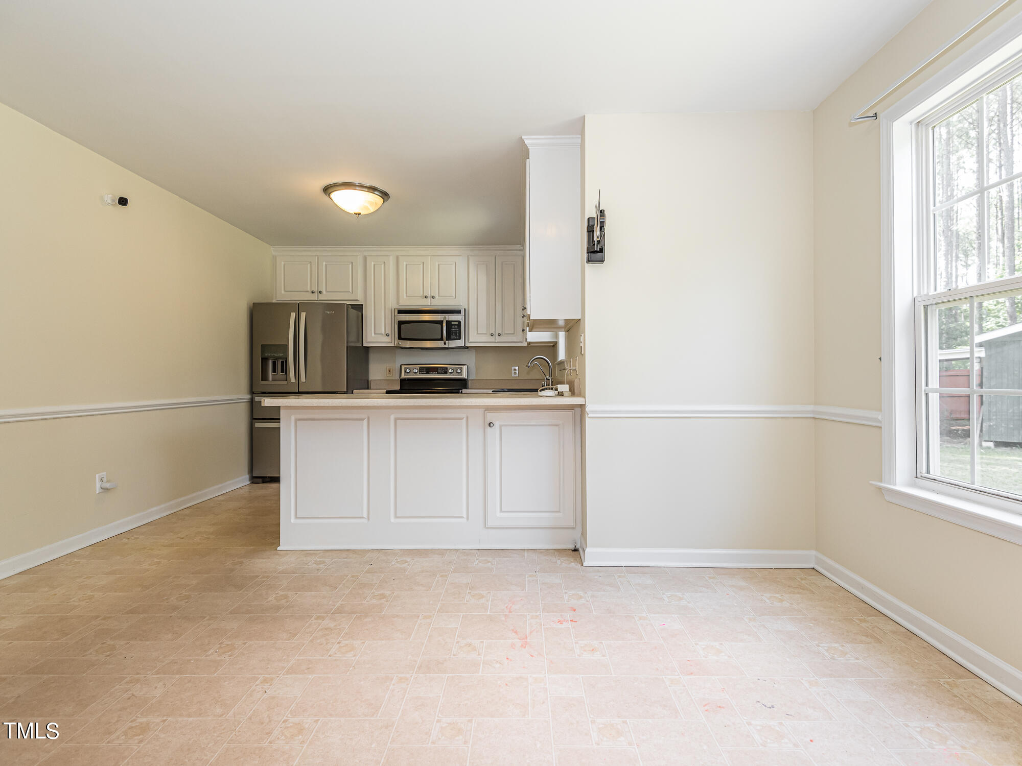 33 Troy Drive Clayton, NC 27520 - Photo 7 of 37 a kitchen with stainless steel appliances a refrigerator sink and microwave