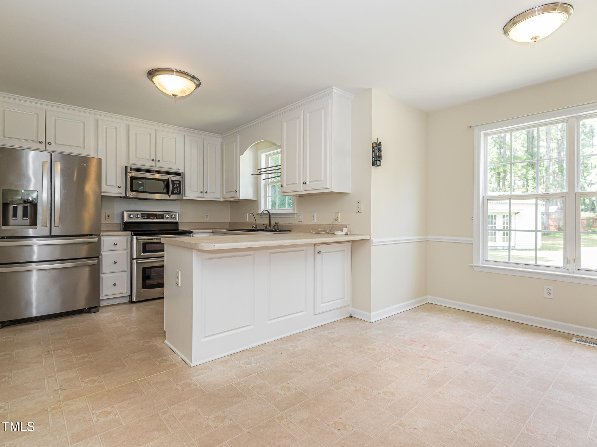33 Troy Drive Clayton, NC 27520 - Photo 8 of 37 a kitchen with stainless steel appliances granite countertop a stove a sink and a refrigerator