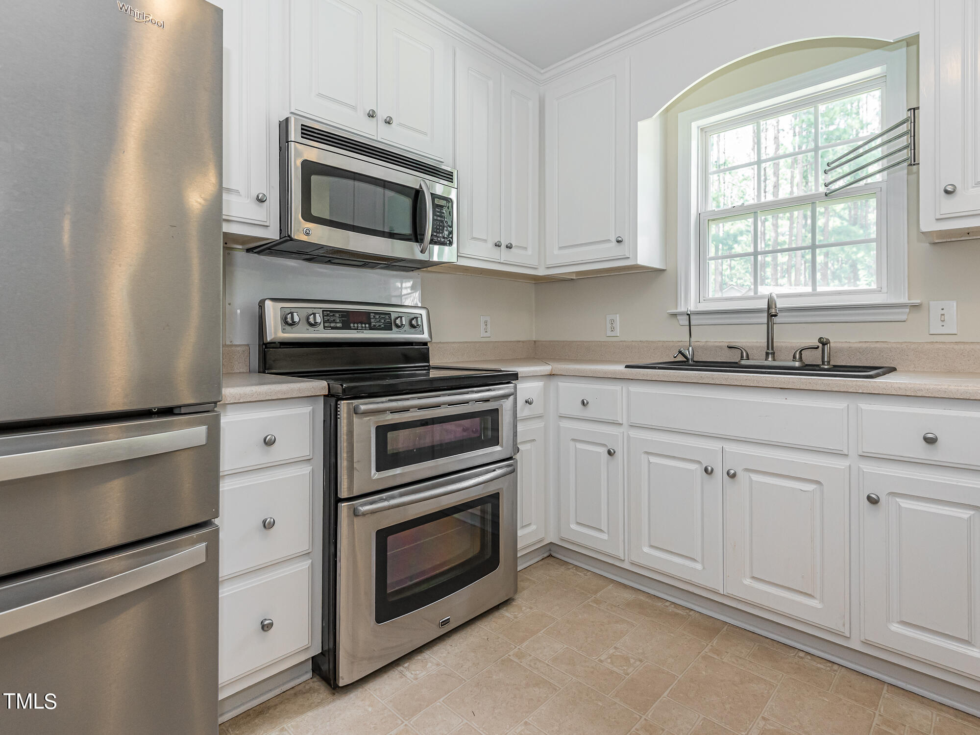 33 Troy Drive Clayton, NC 27520 - Photo 9 of 37 a kitchen with granite countertop white cabinets white stainless steel appliances and a sink