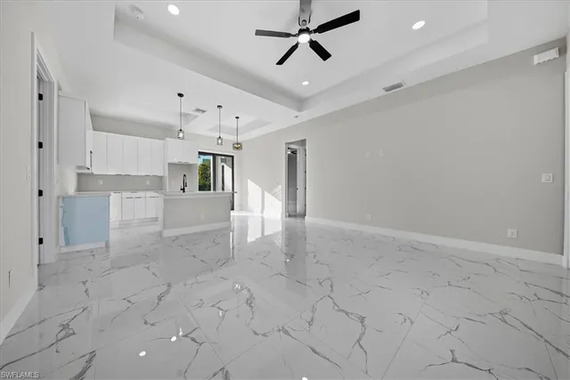a view of kitchen with furniture and refrigerator