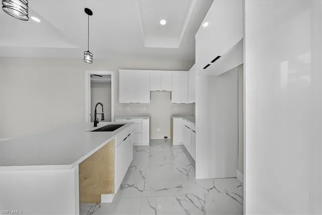 a view of a bathroom with a sink and mirror