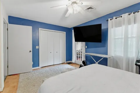a bedroom with a bed and a flat screen tv