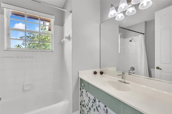 a bathroom with a bathtub and a sink