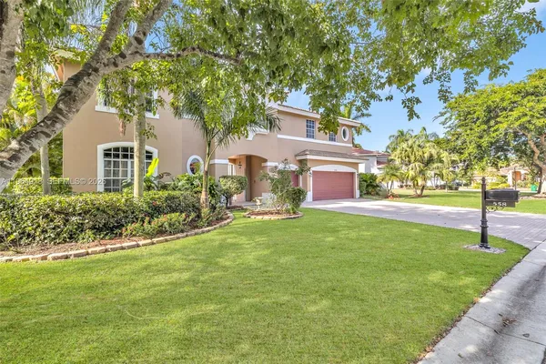 a house is sitting in middle od the grass