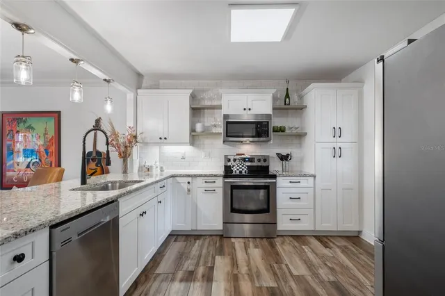 a kitchen with a refrigerator and window