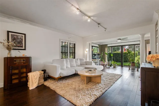 a living room with furniture and a wooden floor