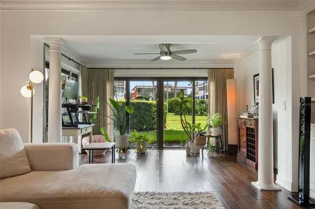 a living room with furniture and a wooden floor