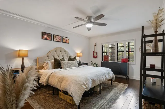 a bedroom with a bed and wooden floor