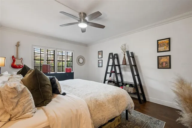 a bed room with a bed and a ceiling fan