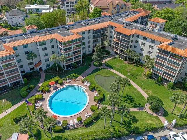 an aerial view of a house with outdoor space and lake view