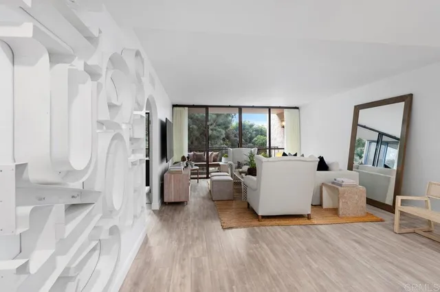 a kitchen with stainless steel appliances kitchen island granite countertop a refrigerator a stove a sink and white cabinets