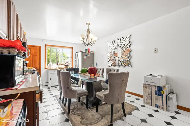 a dining room with furniture garden view and a chandelier