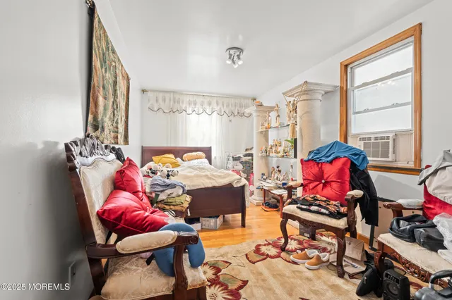 a bedroom with furniture and a window