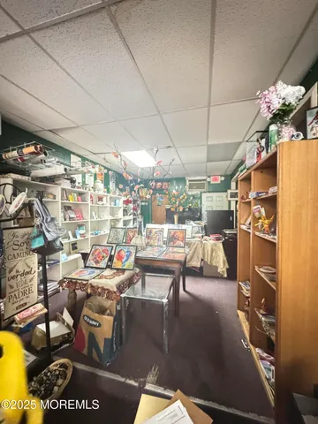 a living room with lots of furniture and a view of kitchen
