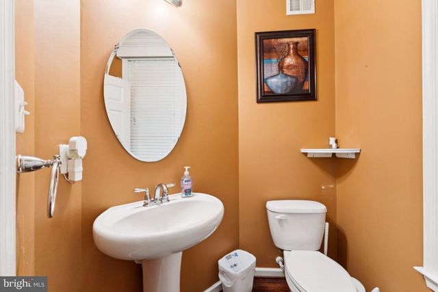 a bathroom with a toilet a sink and a mirror