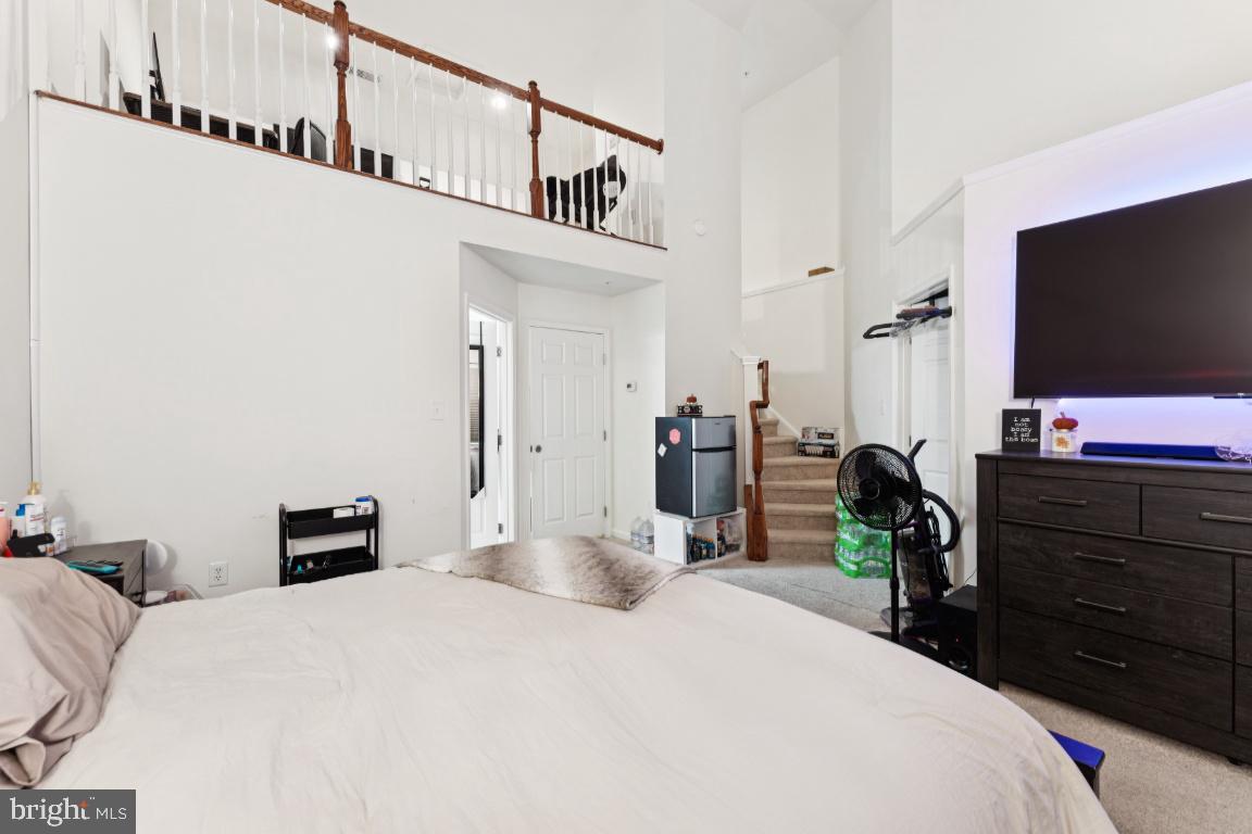 2608 St Marys View Road Accokeek, MD 20607 - Photo 14 of 25 a bedroom with a bed and a flat tv screen on dresser