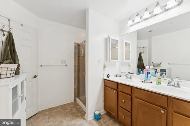 a spacious bathroom with double vanity sink and a mirror