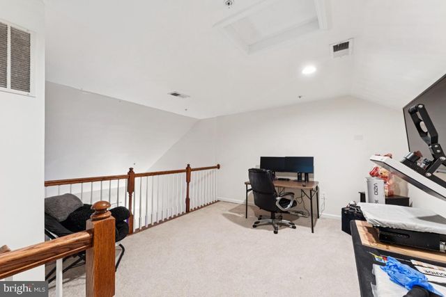 a bedroom with furniture and a flat screen tv