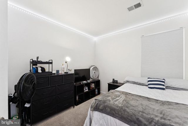 a bedroom with a bed and cabinets