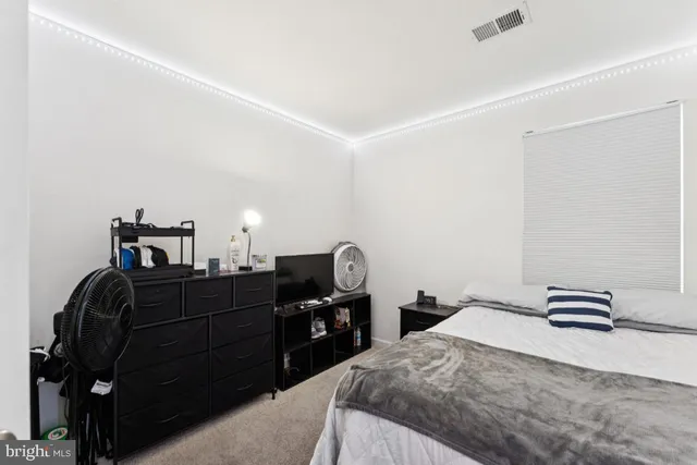 a bedroom with a bed and cabinets