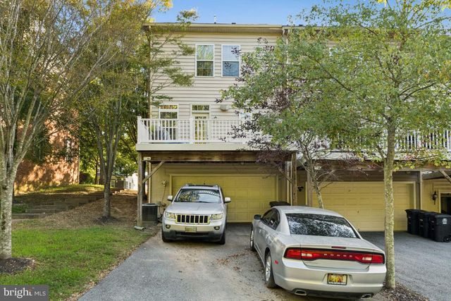 a car parked in front of a house with a lake