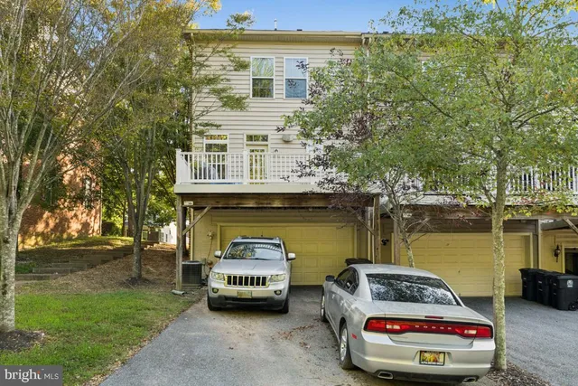 a car parked in front of a house with a lake
