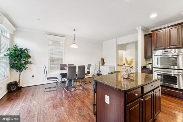 a kitchen with sink refrigerator and microwave