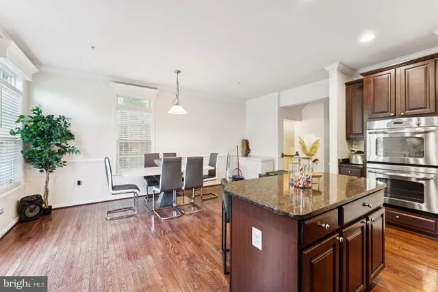 a kitchen with sink refrigerator and microwave