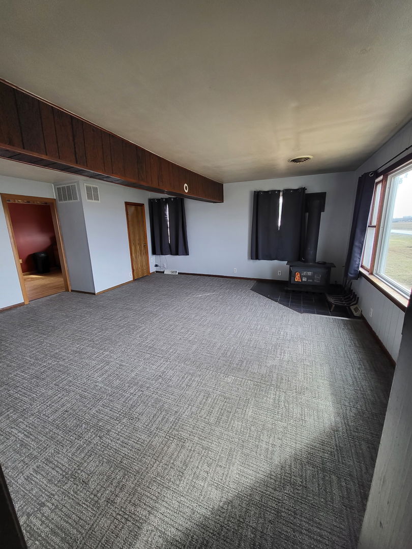 1884 Banks Road Erie, IL 61250 - Photo 3 of 12 a view of empty room with wooden floor and window