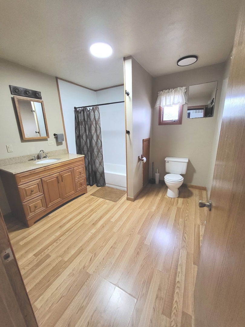 1884 Banks Road Erie, IL 61250 - Photo 5 of 12 a bedroom with a bed and a dresser