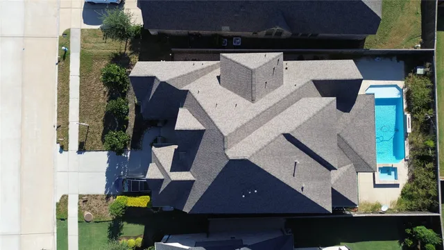 an aerial view of a house with a yard
