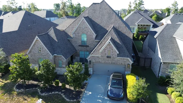 a aerial view of a house next to a yard