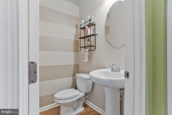 a kitchen with a table chairs refrigerator and cabinets