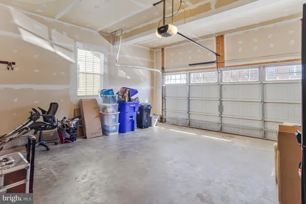 a large kitchen with stainless steel appliances granite countertop a stove a sink dishwasher and a refrigerator with wooden floor