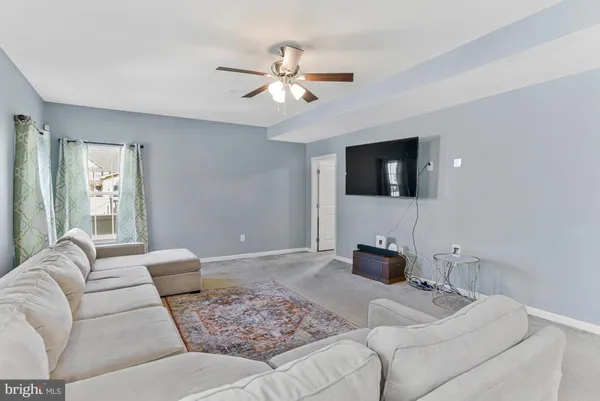 a spacious bedroom with a bed and a chandelier