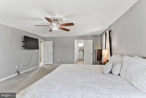 an empty room with closet and a chandelier fan