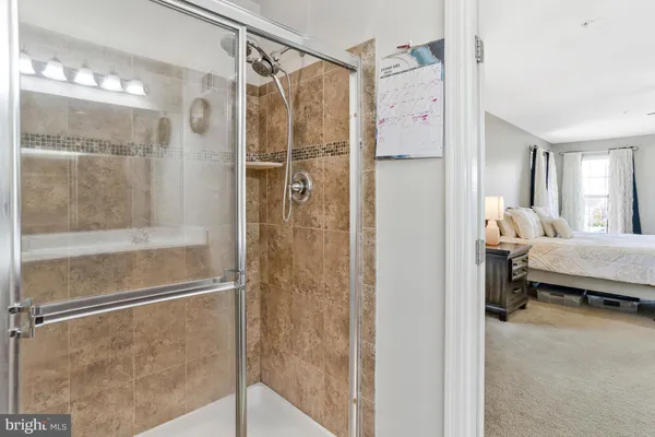 a living room with furniture and a ceiling fan